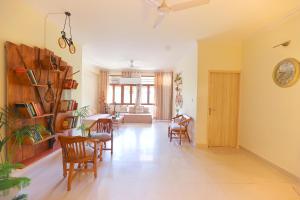 a living room with chairs and a dining room at Soul'Stay- A HomeStay & Retreat Center in Agra +43 photos