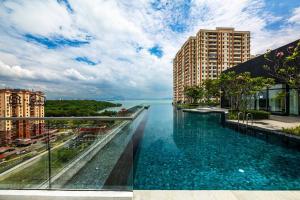 a infinity pool with a view of the water at Urban Suites with Spectacular High Floor View #3BR #03 in Jelutong