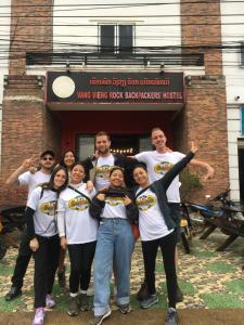 a group of people standing in front of a building at Vangvieng Rock Backpacker Hostel in Vang Vieng