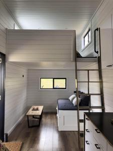 a bedroom in a tiny house with a bunk bed at Tiny Zoe in Mount George