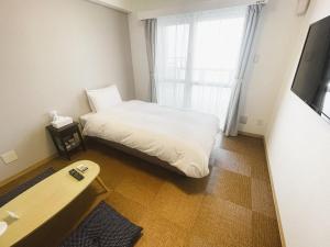 Letto o letti in una camera di BiBi Hotel Cosmos Shintoshin