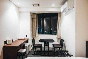 a room with a desk and chairs and a table and a window at TAPSTAY HOTEL - Vacation STAY 35228v in Saga