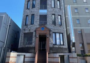 a tall brick building with a door in front at TAPSTAY HOTEL - Vacation STAY 35241v in Saga