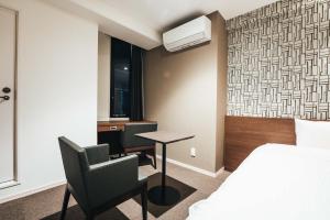 a hotel room with a bed and a desk and a chair at TAPSTAY HOTEL - Vacation STAY 35203v in Saga
