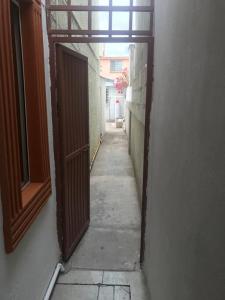 an empty hallway with an open door to an alley at Habitacion #1 in Chihuahua