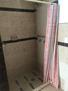 a shower with a shower curtain in a bathroom at Habitacion #1 in Chihuahua