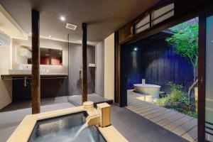 a bathroom with a tub and a shower and a bath tub at Kyoto Machiya Zeniyacho in Kyoto