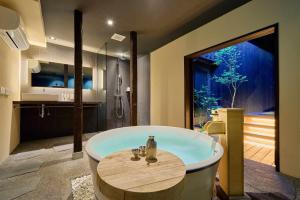 a large bathroom with a tub and a sink at Kyoto Machiya Zeniyacho in Kyoto