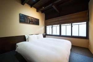 Rúm í herbergi á Kyoto Machiya Zeniyacho