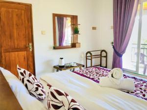 a bedroom with a bed and a window at Star Holiday Home in Nuwara Eliya