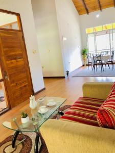 a living room with a couch and a table at Star Holiday Home in Nuwara Eliya