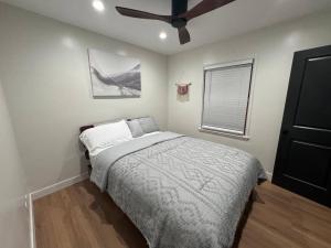 a bedroom with a bed and a ceiling fan at Mid-Century Gem in Long Beach in Long Beach