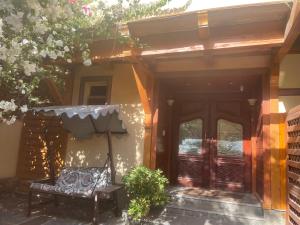 a bench sitting outside of a house with an umbrella at Apartment in a villa with pool and garden in Cairo