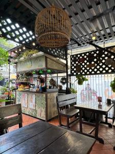 a restaurant with wooden tables and chairs and a counter at KC guest house in Bangkok