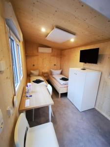 a small room with a refrigerator and a couch at Landhaus Herdt in Lauda-Königshofen