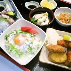 a table with a plate of food and other foods at Hotel Alpha-One Tottori in Tottori