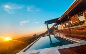 a view of the sunset from a hotel balcony at Luxurious Hinterland Guest House with HEATED POOL Sleeps 10 Brisbane Scenic Rim Gold Coast in Canungra