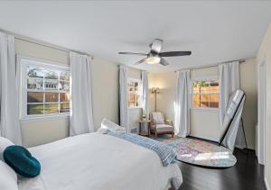 a bedroom with a bed and a ceiling fan at Capital Oasis - Family Friendly & Centrally Located - Mins to DC Smithsonians and Top Spots in Alexandria