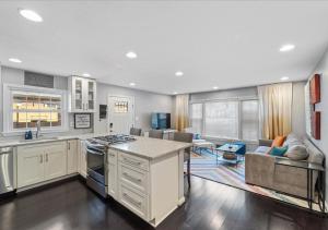 a kitchen and living room with a stove and a couch at Capital Oasis - Family Friendly & Centrally Located - Mins to DC Smithsonians and Top Spots in Alexandria