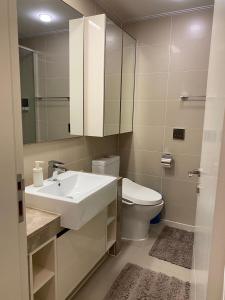 a bathroom with a sink and a toilet and a mirror at Хайвилл Астана G блок in Promyshlennyy