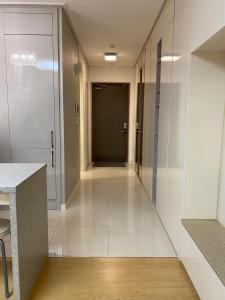 a hallway with white walls and a door in a building at Хайвилл Астана G блок in Promyshlennyy