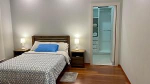 a bedroom with a bed and a walk in shower at Altos de Tababela in Tababela