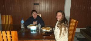 a man and woman sitting at a table with food at Dedunu Guest in Badulla
