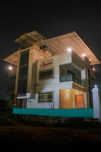 a building with lights on top of it at night at Sukhakarta Holiday Home in Veshvi