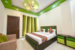a bedroom with a bed and a ceiling fan at FabHotel Kempty Lake Resort in Mussoorie