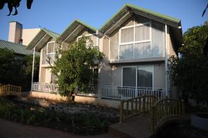 a large house with windows and a porch at Mango Leaf Lake Resort in Pune