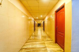 an empty hallway in a building with a red door at FabHotel Skyry I in Coimbatore