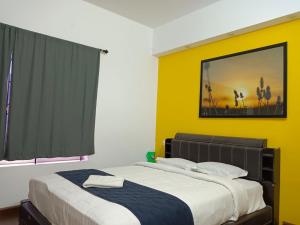 a bedroom with two beds and a painting on the wall at Savi's home stay in Ooty +4 photos