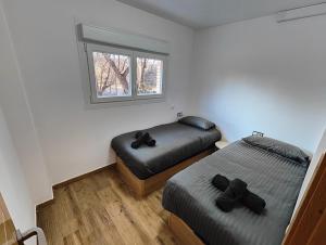 a bedroom with two beds and a window at Lovely Flat Fira Barcelona in Las Corts