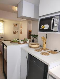 a kitchen with a white counter top with a microwave at Condo At Azure North San Fernado in San Fernando