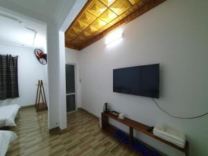 a living room with a flat screen tv on a wall at Cyan Sapa Homestay in Sa Pa