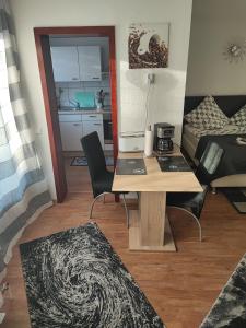 a living room with a table and a room with a bed at Apartment in der Rattenfängerstadt Hameln in Hameln +4 photos