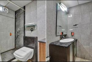 a bathroom with a toilet and a sink at HOTEL COSMOS in Bijnaur