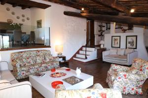 a living room with couches and a table at La Cipressa in Greve in Chianti