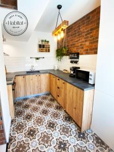 a kitchen with a counter and a tile floor at habitat The River Apartment in Ruse