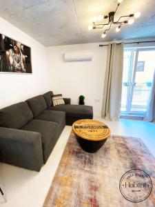 a living room with a couch and a table at habitat The River Apartment in Ruse