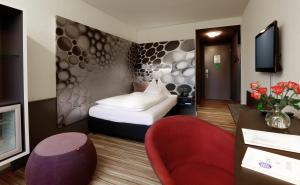 Llit o llits en una habitació de Hotel Thurgauerhof Self-Check-in