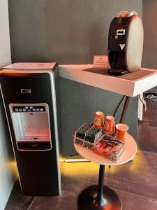 a counter with a small refrigerator and a shelf with cups at Carta Hotel Kyoto Gion in Kyoto