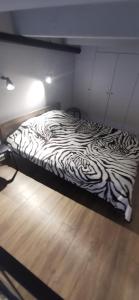a zebra print bed in a room with a wooden floor at Lofto tipo 2 kambarių butas in Kaunas