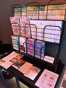 a rack of books on a table with a table with a table at Carta Hotel Kyoto Gion in Kyoto