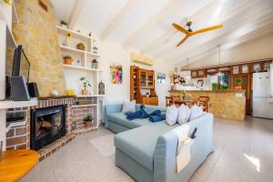 a living room with a blue couch and a fireplace at Finca Son Macia in Selva