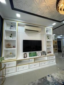 a large white entertainment center with a flat screen tv at VVIP LUXURIOUS HOMESTAY PUTRAJAYA FREE WIFI AND PARKING in Putrajaya