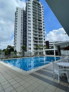 a swimming pool in front of a large building at VVIP LUXURIOUS HOMESTAY PUTRAJAYA FREE WIFI AND PARKING in Putrajaya