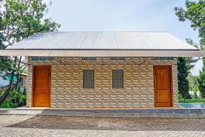 a brick building with two doors and a roof at OYO 91679 Juanda Homestay Syariah in Pasuruan