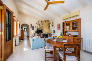 a living room with a table and a blue couch at Finca Son Macia in Selva