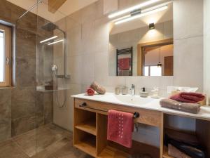 ein Bad mit einem Waschbecken und einer Dusche in der Unterkunft Appartements Kafmahof in Söll